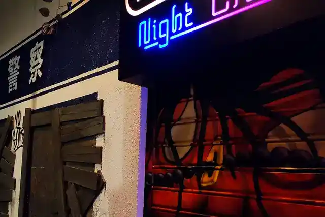 Neon lights and police station shopfront in the Enigma City sets