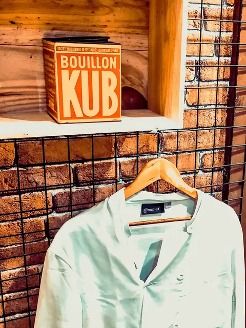 Chef’s jacket hanging in front of a brick wall, Magien’s